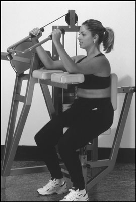 Use the triceps-extension machine at the gym as an alternative to the triceps kickback. [Credit: Ph