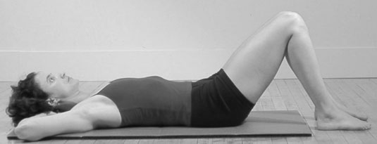 Lie down on your back with your knees bent, feet flat on the floor about hip distance apart.