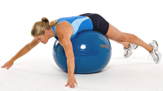Lie with your stomach and waist on the ball and your legs extended behind you.