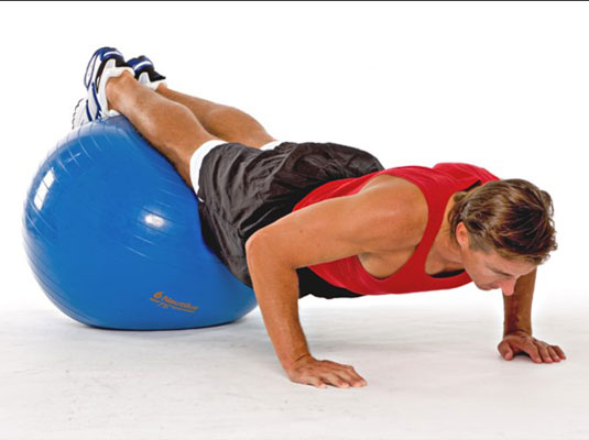 Inhale as you lower toward the floor with the upper body, bending your elbows out to the side.