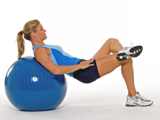 Sit tall on the ball and roll down slowly until only your shoulders touch the ball.