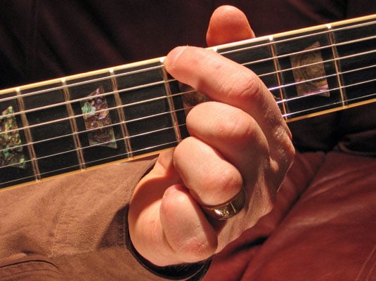 Play the fifth fret of the low E (6th) string and then play the open A (5th) string.