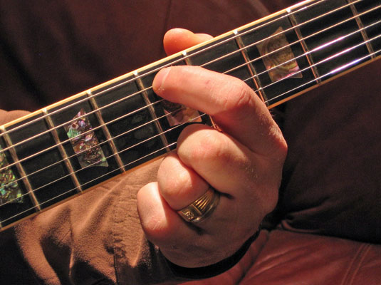 Play the fifth fret of the A (5th) string and then play the open D (4th) string.