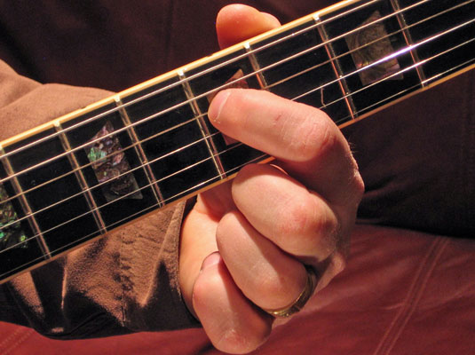 Play the fifth fret of the D (4th) string and then play the open G (3rd) string.
