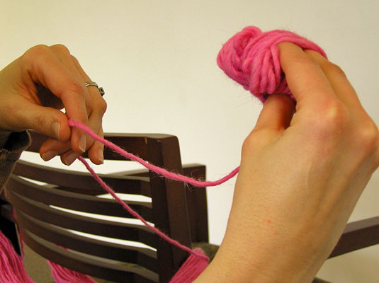 Continue wrapping yarn loosely around the folded butterfly (and your fingers).