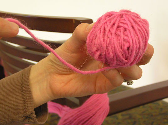 Slip the yarn off your fingers, turn the ball, and continue to wrap the yarn.