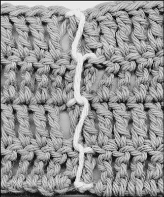At the end of the seam, weave the yarn back through several stitches to secure.