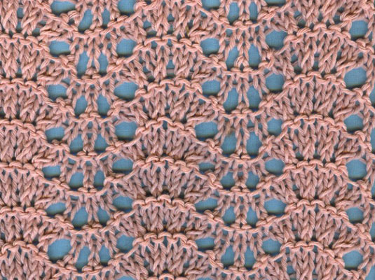 The blue background shows off the pattern in feather and fan knit lace.