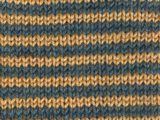 Continue working each color for two rows apiece as you follow the knitting directions in your pattern.