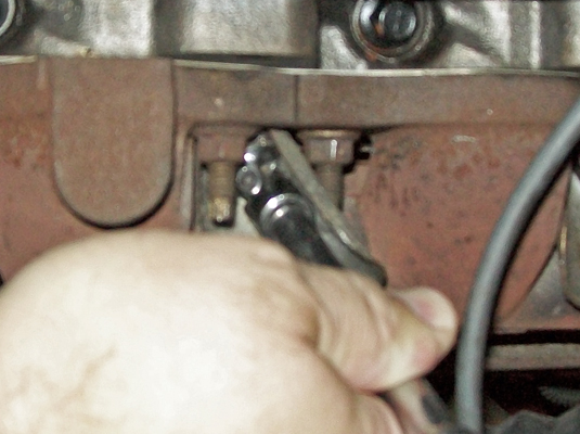 Slip the spark plug socket over the spark plug, attach the ratchet handle, and continue turning the plug clockwise until you meet resistance.