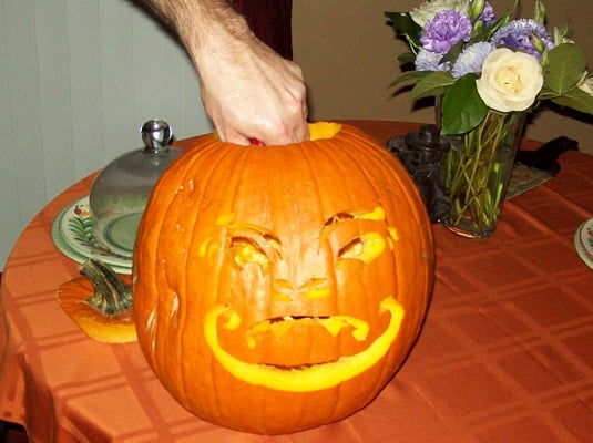 Place a candle in a glass votive cup inside your pumpkin and light it.