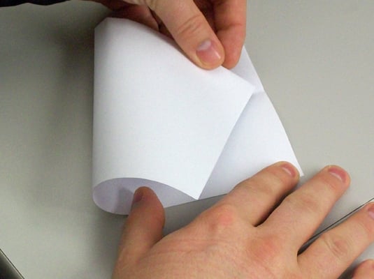 With the fold on your left, fold the bottom left corner up to the crease in the center of the top edge.