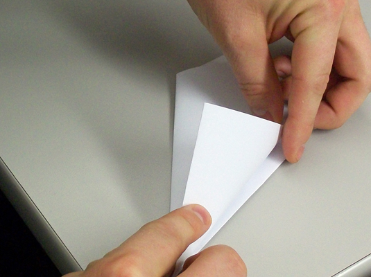 Flip the paper over and fold that extra triangle back over the nearest edge.