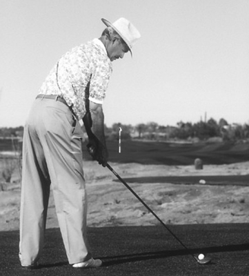 Twist your upper body to the right until you can set the clubhead behind the ball.