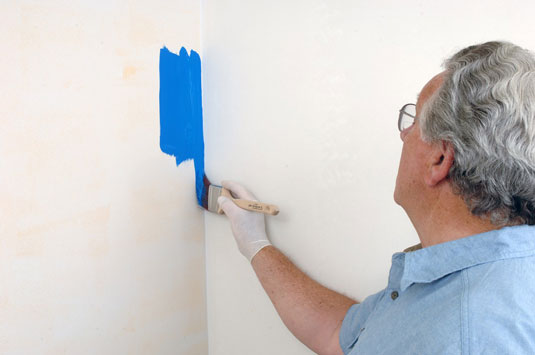 Paint a downward stroke up to 12 inches long in the corner or use a horizontal stroke along the ceiling or baseboard.