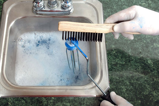 Wash the roller cage in a sink filled with sudsy water.