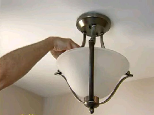 Screw in new light bulbs, install the cover, and turn on the power.