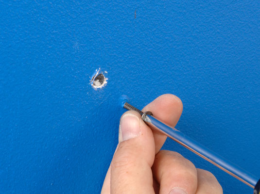 Drive new drywall screws a couple of inches on either side of the nail pop.