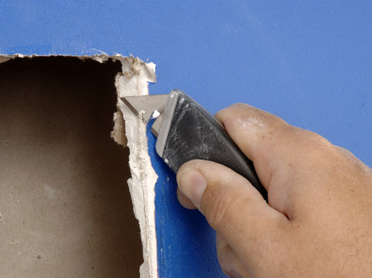 Use a sharp utility knife to trim away any loose or protruding paper facing or loose pieces of gypsum.