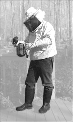 Protective clothing comes in various styles, from minimal to full coverage. This beekeeper uses a v