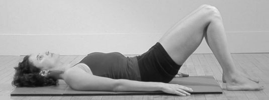 Lie on your back with your knees bent and your feet flat on the floor, approximately hip distance apart.