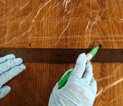 Using a ruler and a felt-tip permanent marker, make indicator marks on the plastic wrap, about 6 inches apart.