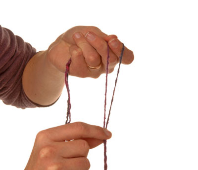With your spinning hand, reach down and give the spindle a firm twist to the left.