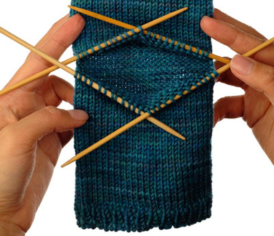 Re-arrange the stitches onto four needles