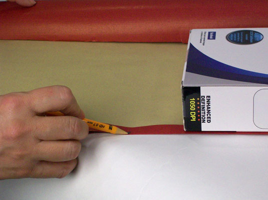 Determine the width of the paper and trim the excess.