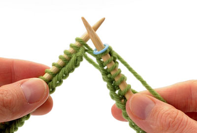 Continue knitting the stitches on the left needle, sliding them along the cable as needed. Knit around on all stitches until you reach the end of the round.
