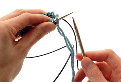 Hold your work in your left hand and slide the front set of stitches to the right until they are resting on the needle.