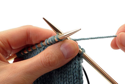 Rotate your work again so that the stitches you are going to work next are facing you, slide the front stitches onto the needle tip and the back stitches onto the cable, and work across the front set of stitches.