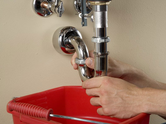 Slide the two washers from the old trap onto the new trap.