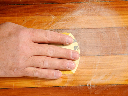 Sand lightly and apply the second coat of polyurethane.