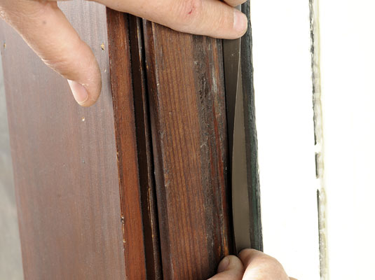 Apply the first piece of weather stripping to the inner sash.