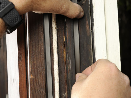 Lower the outer sash as far as it will go and install the weather-stripping on this sash the same way that you did on the inner sash.