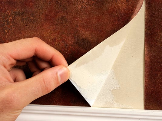 Slowly peel back the wallpaper at a 10- to 15-degree angle.