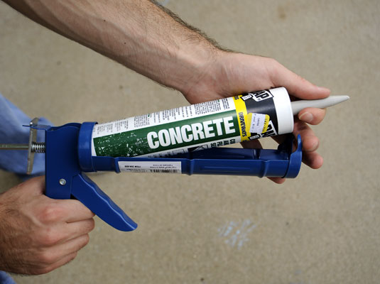 Put the concrete patch tube in a caulking gun.