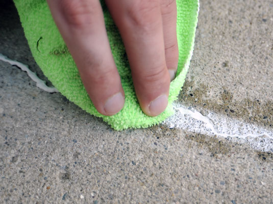 Wipe excess patch off the crack with a wet rag.