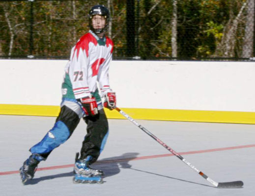 A hockey player skating through a rink.