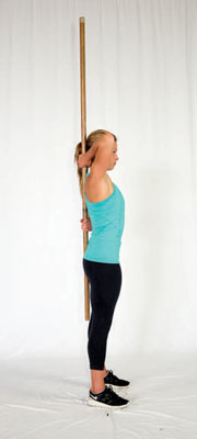 Hold the broomstick with one arm behind your neck and one arm behind your low back.