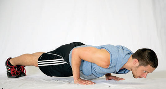 As you descend into the push-up, keep your elbows pointed back and tucked in to your sides.