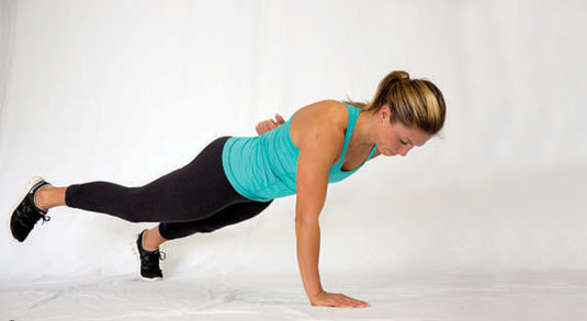 Set up at the top of your push-up position and lift one arm and the opposite leg off the ground.