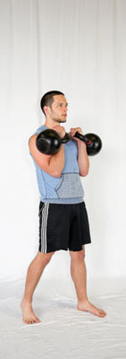 Clean two kettlebells or dumbbells up into the rack position.