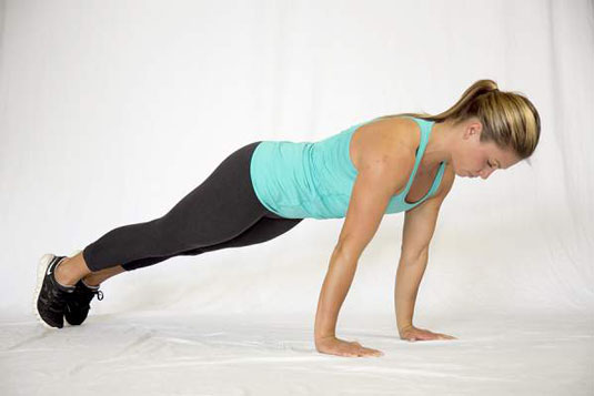 Tuck in your toes, tense your whole body, and push yourself up to the top of a push-up position.