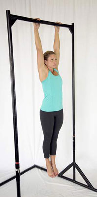 Hang from a bar or a set of rings with a shoulder-width grip.