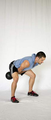 <b>Swing by hiking the kettlebell back between your legs as you would a football.</b>