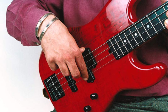 Reach for your high string (the one closest to your feet) with your index or middle finger.