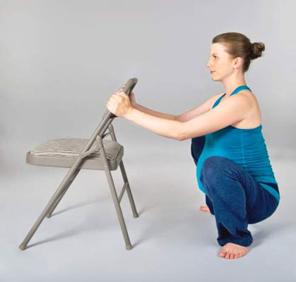 Supported chair squatting posture: Modified ardha utkatasana
