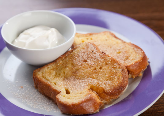 A plate of french toast with creme fraiche.